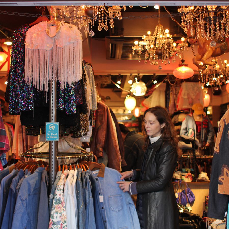 A woman browses racks of shirts and jackets at Little Trip to Heaven in Tokyo.
