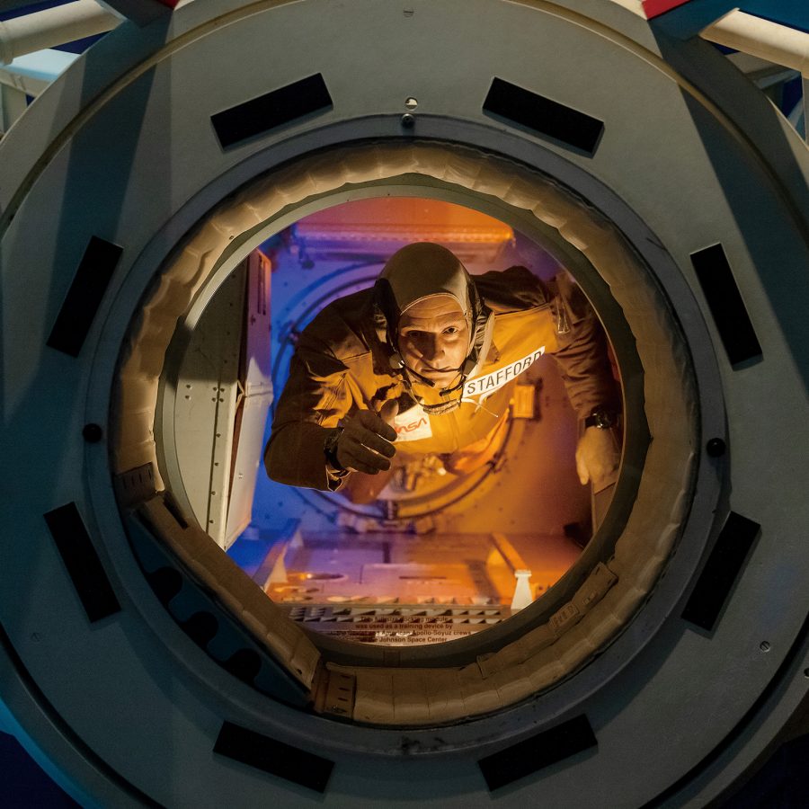 A Space Center Houston exhibit of an astronaut floating in a spacecraft. 