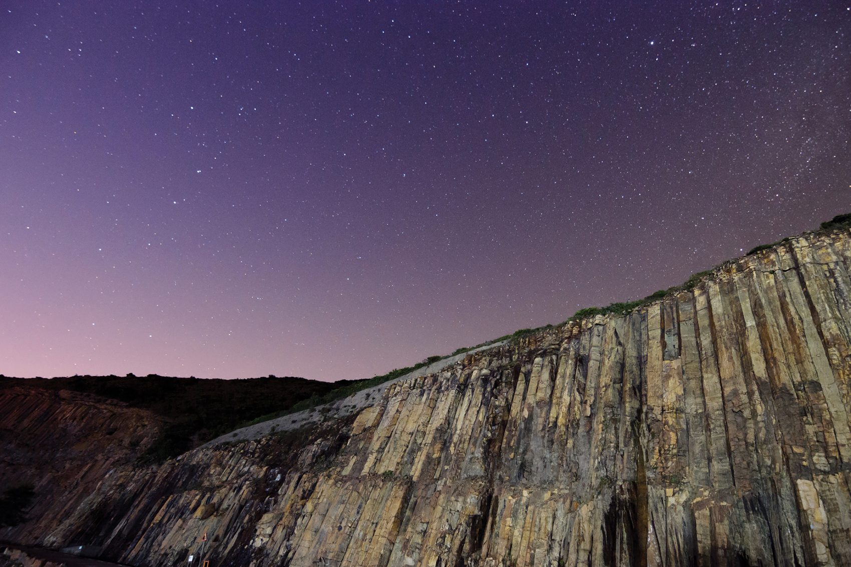 Night landscape shot of Sai Kung’s hexagonal rock columns in Hong Kong. 