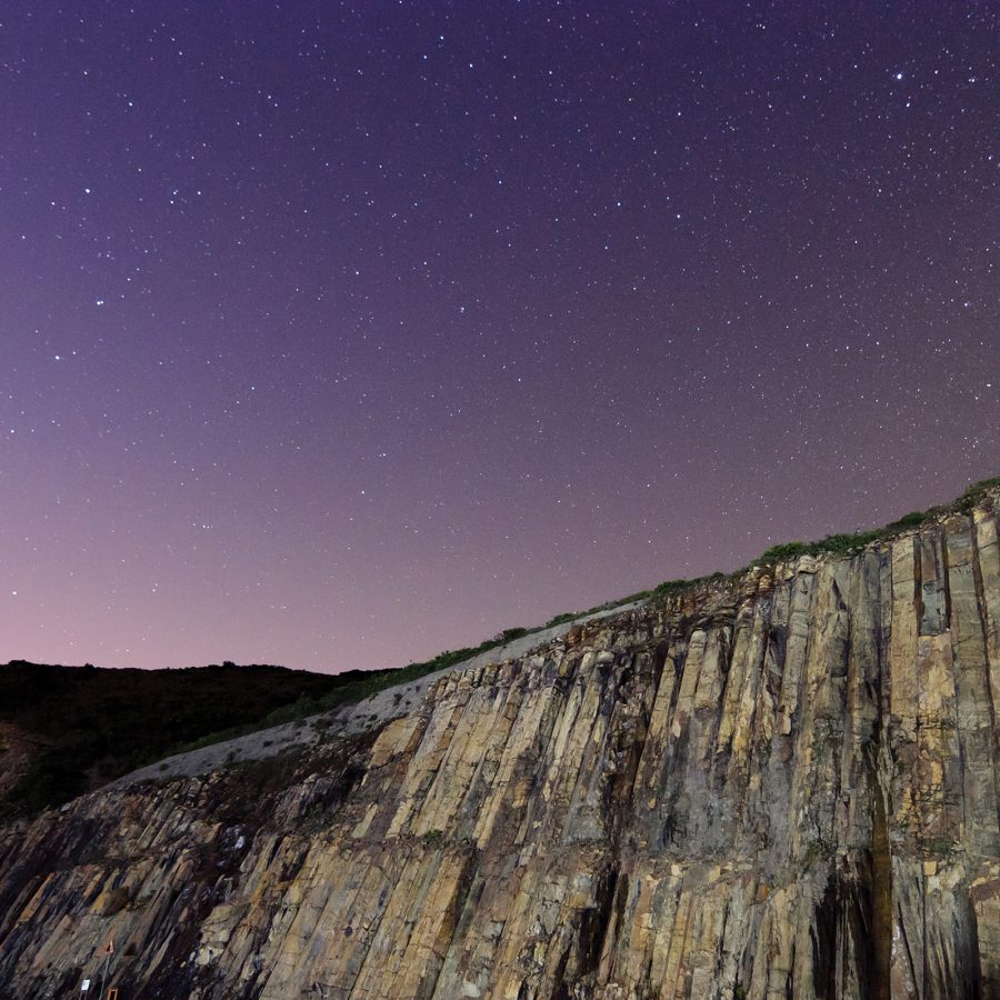 Night landscape shot of Sai Kung’s hexagonal rock columns in Hong Kong. 