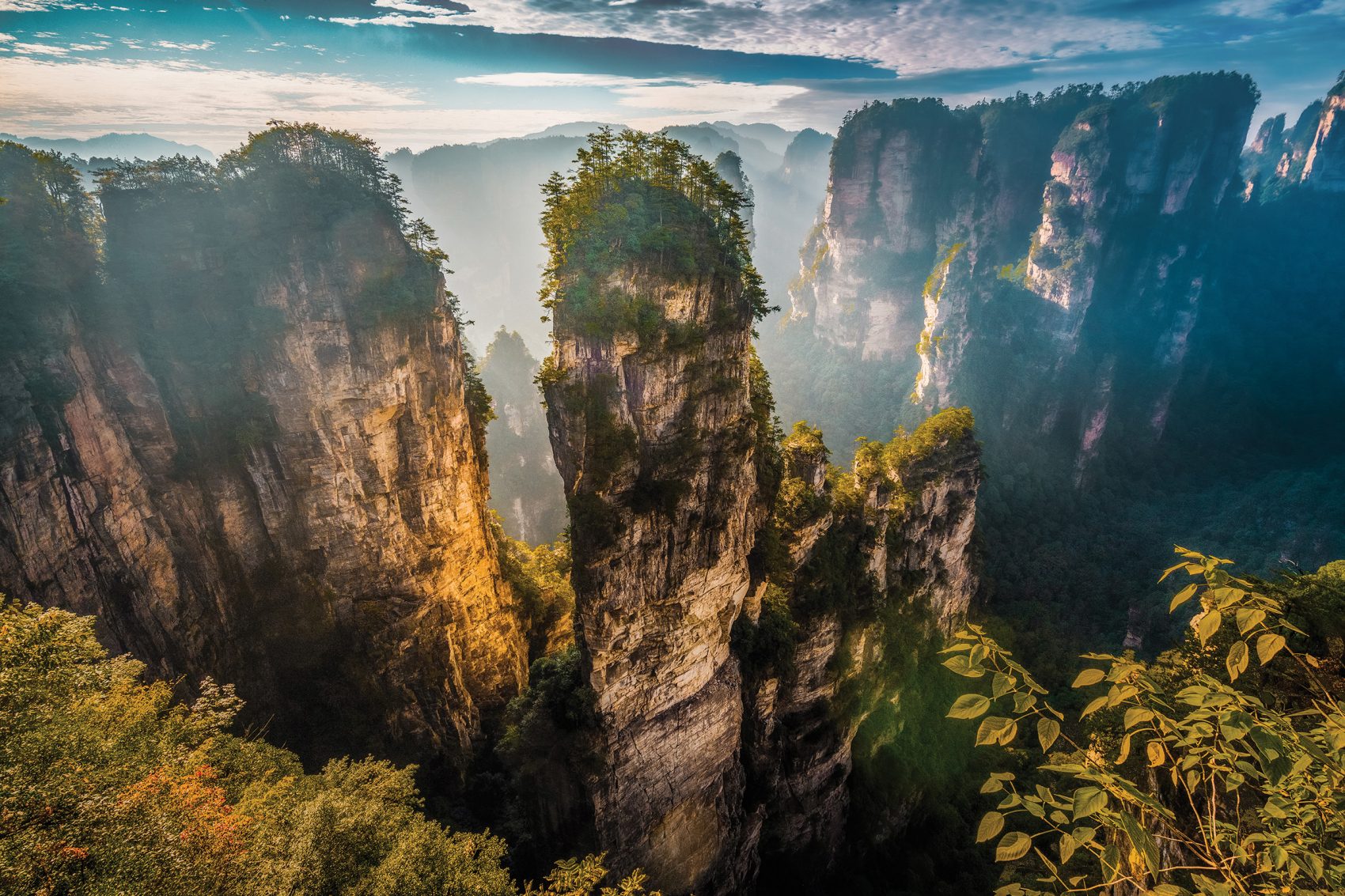 Misty view of the Zhanjiajie National Forest Park and its stone pillars.