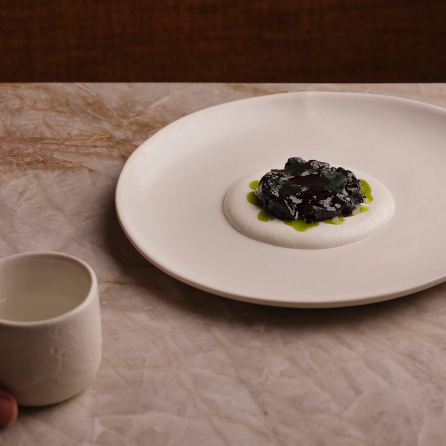 A dish is arranged artfully on a marbled counter at Plates London, the UK’s first vegan restaurant to earn a Michelin star. 