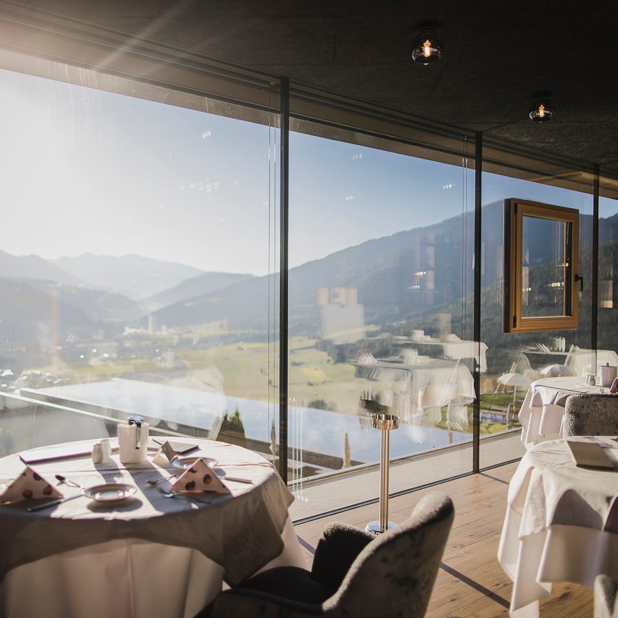 Dining room overlooking the pool at Hotel Hubertus, Italy. 