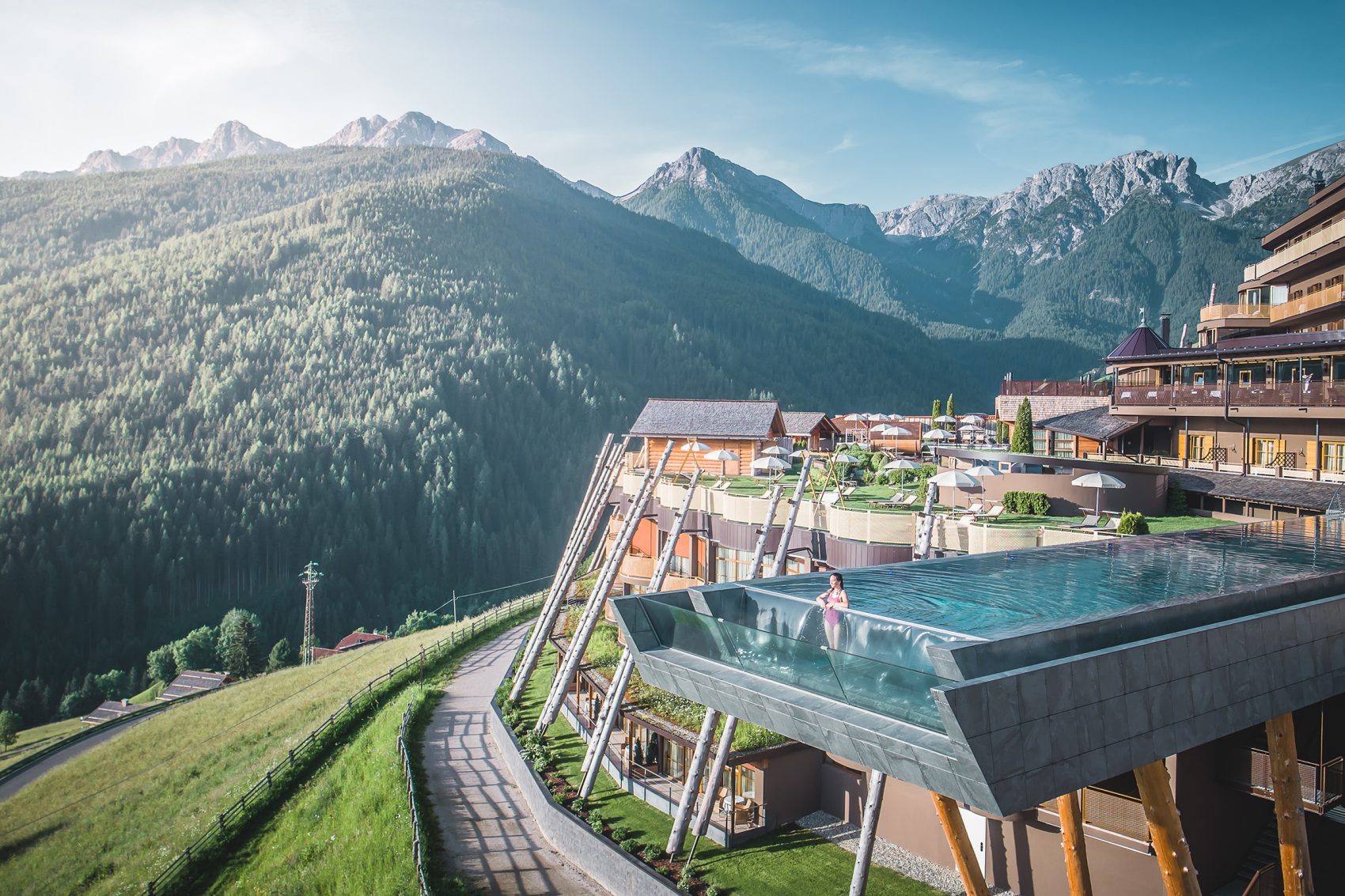 Landscape view of someone stood in the pool at Hotel Hubertus, Italy.