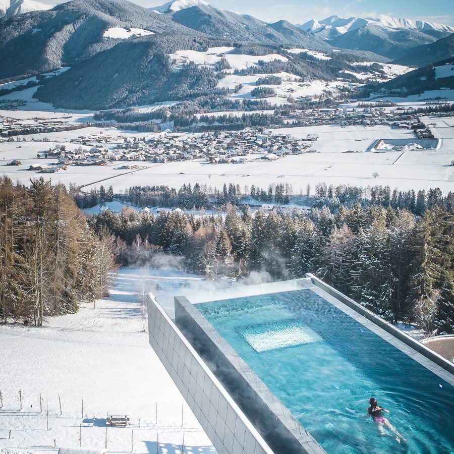 Pool view from Hotel Hubertus, Italy, looking onto the snowy mountains.