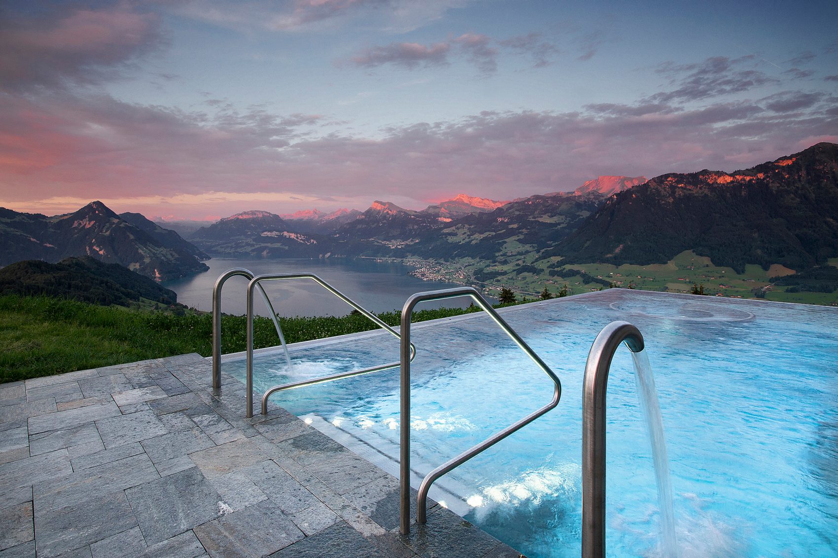 Outdoor pool at Hotel Villa Honegg, Switzerland, overlooking the mountains.