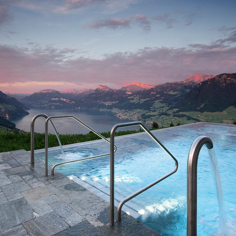 Outdoor pool at Hotel Villa Honegg, Switzerland, overlooking the mountains.