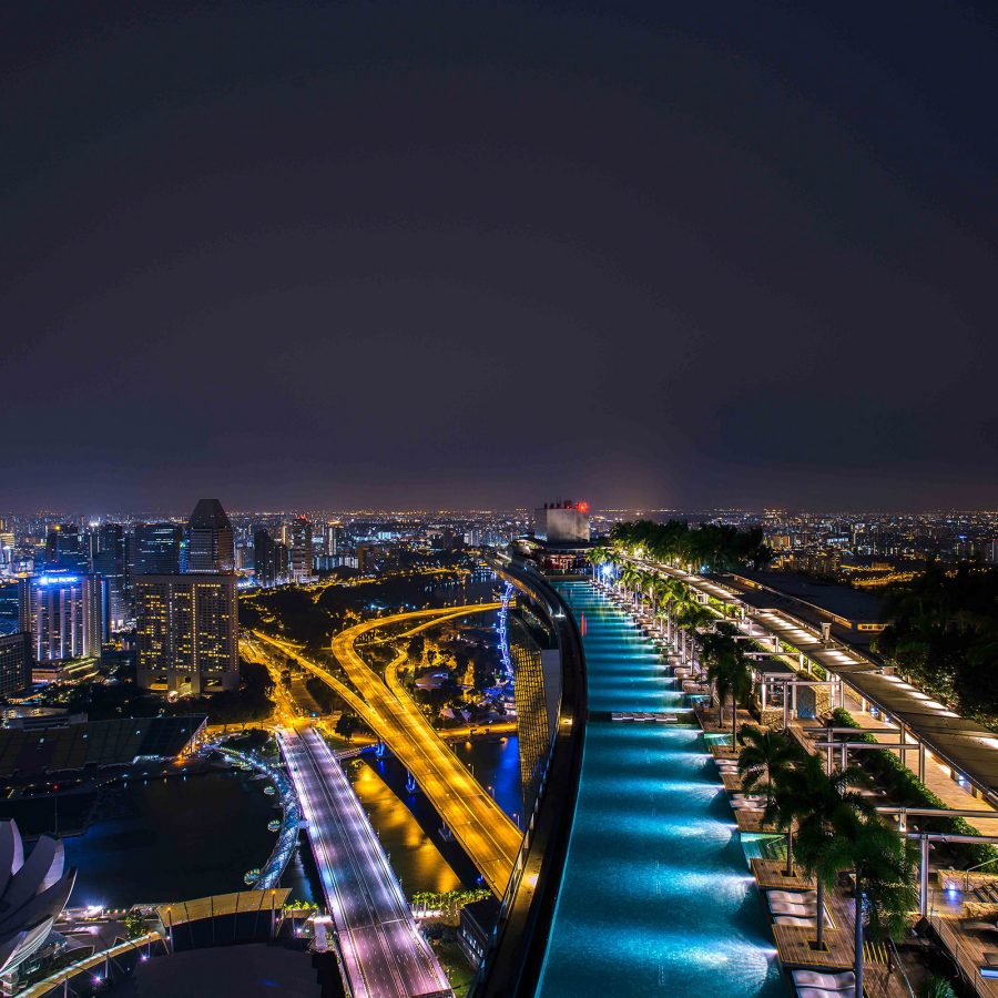 Nightime view of the pool at Marina Bay Sands, Singapore with the city in the background. 