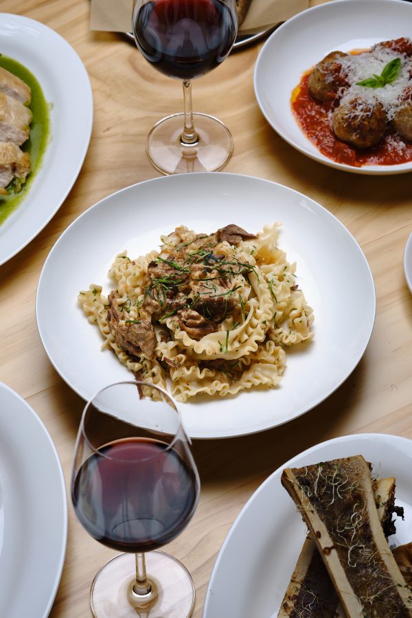 A pasta surrounded by various dishes on the dining table served at Tabia in Hong Kong.