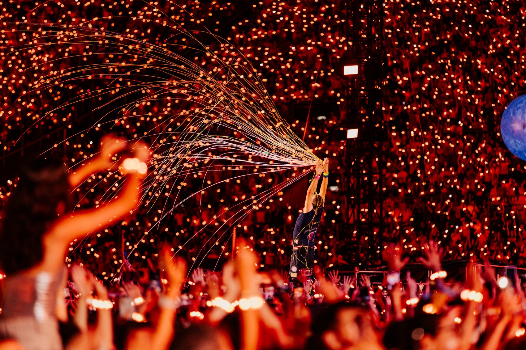 A shot from a Coldplay concert with neon lights. 