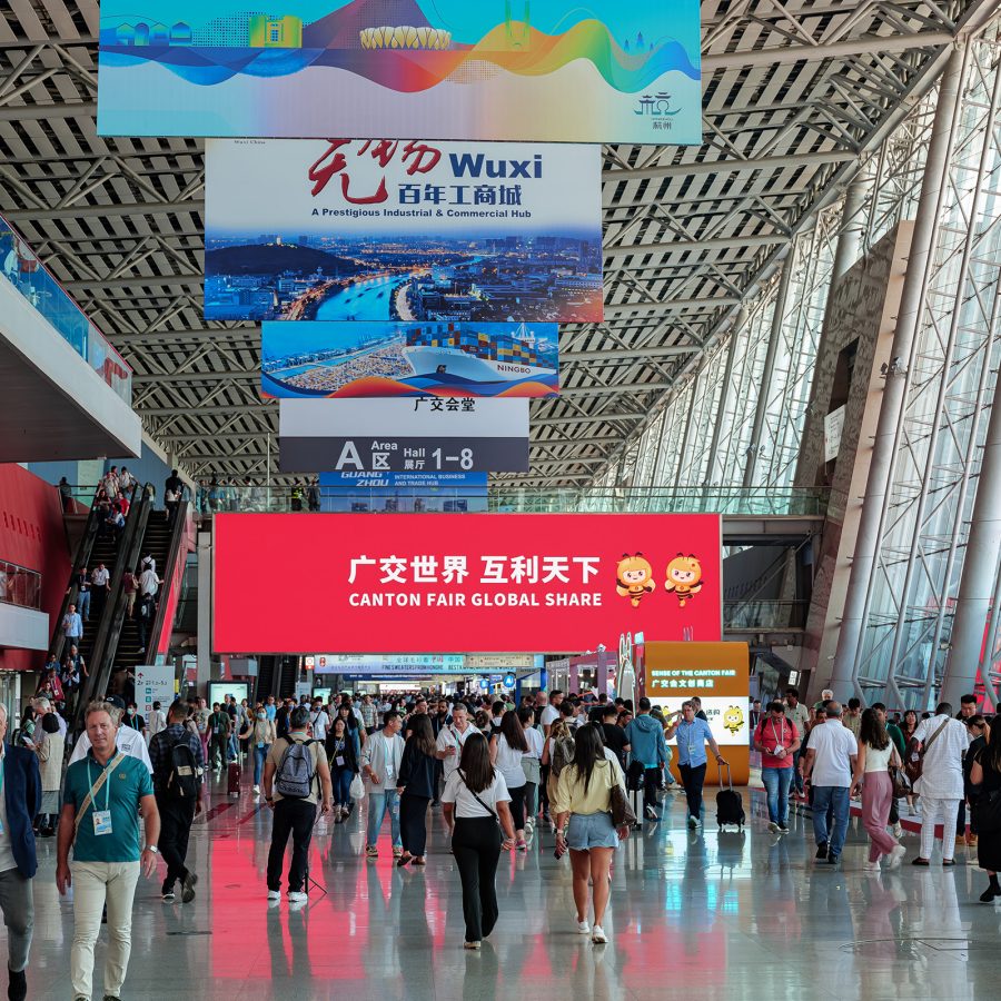 Crowds walk through a vast light-filled exhibition hall at the Canton Fair.