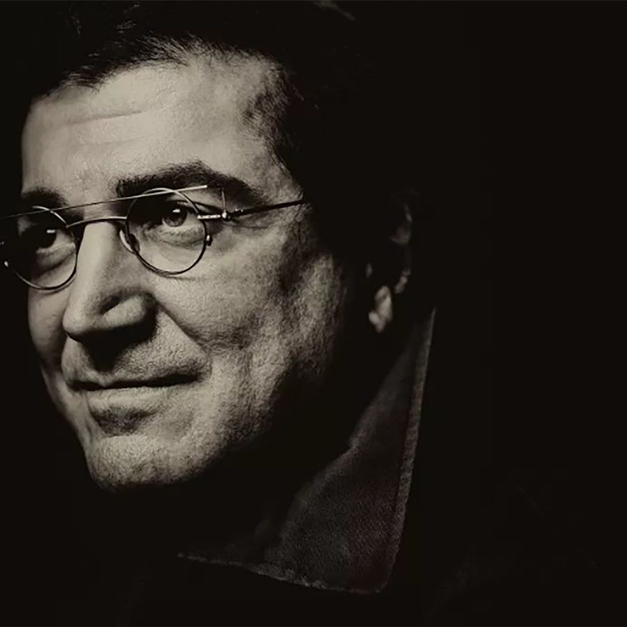 A close-up greyscale portrait photo of pianist Sergei Babayan, in which only his face is visible against a dark background.