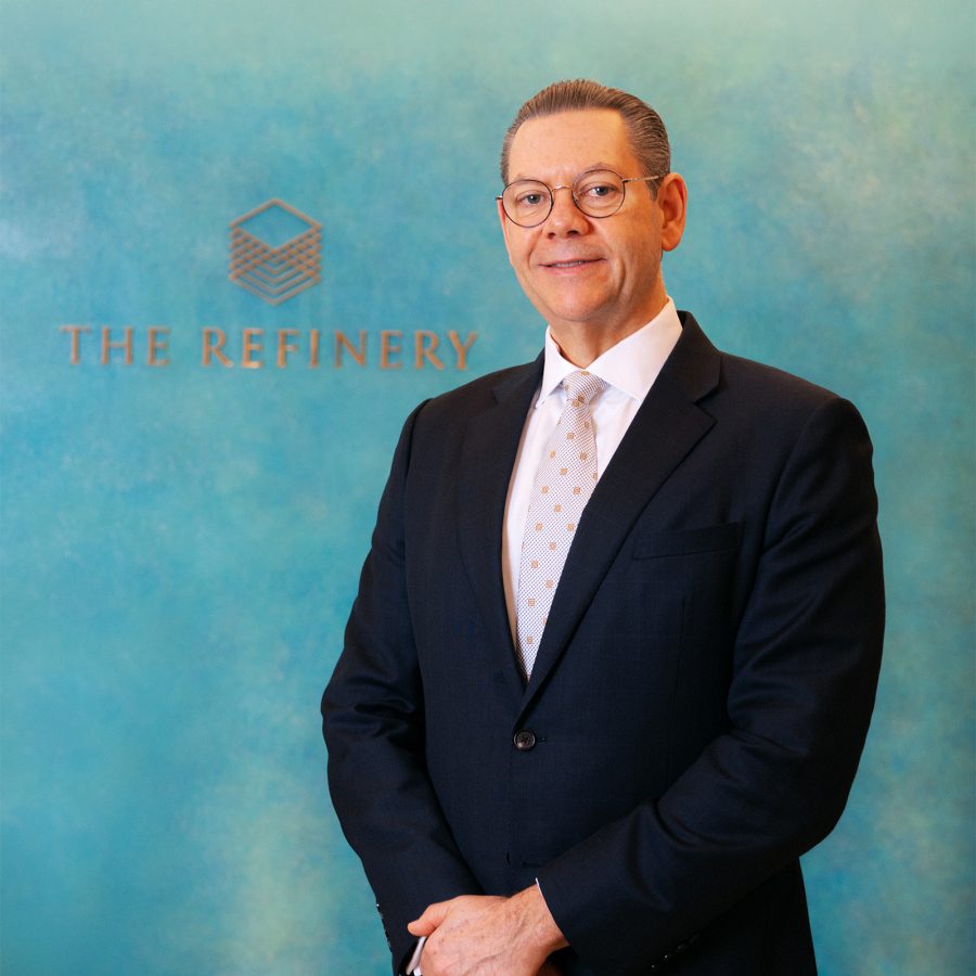 A portrait shot of Jonathan Bailey, General Manager of The Refinery private member’s club, posing infront of The Refinery club logo at the main entrance.