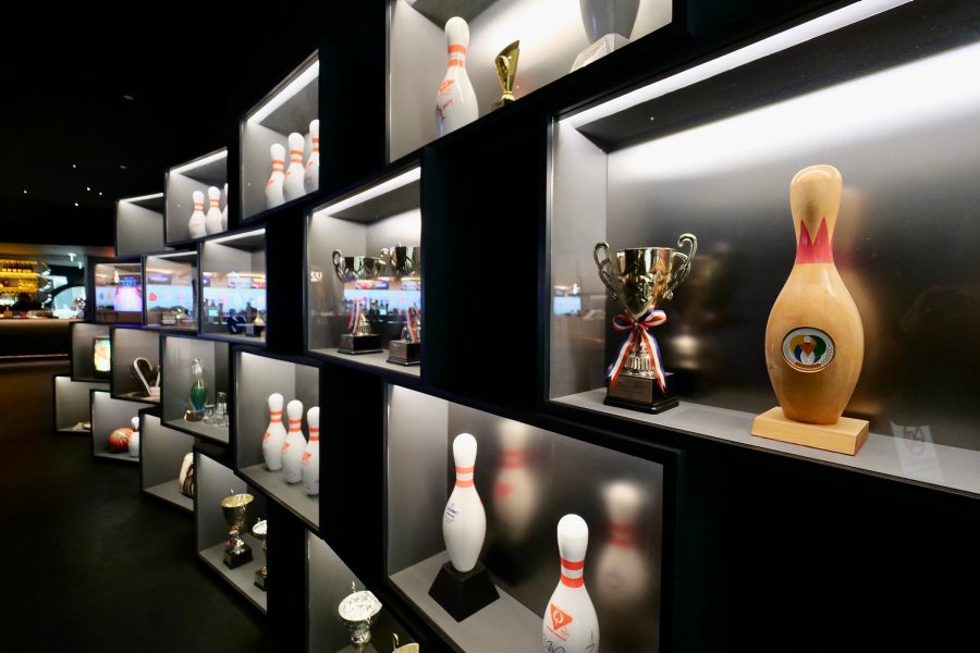 The entrance display of bowling pins and trophies at Top Bowl Tenpin Bowling in Kai Tak Sports Park, Hong Kong.