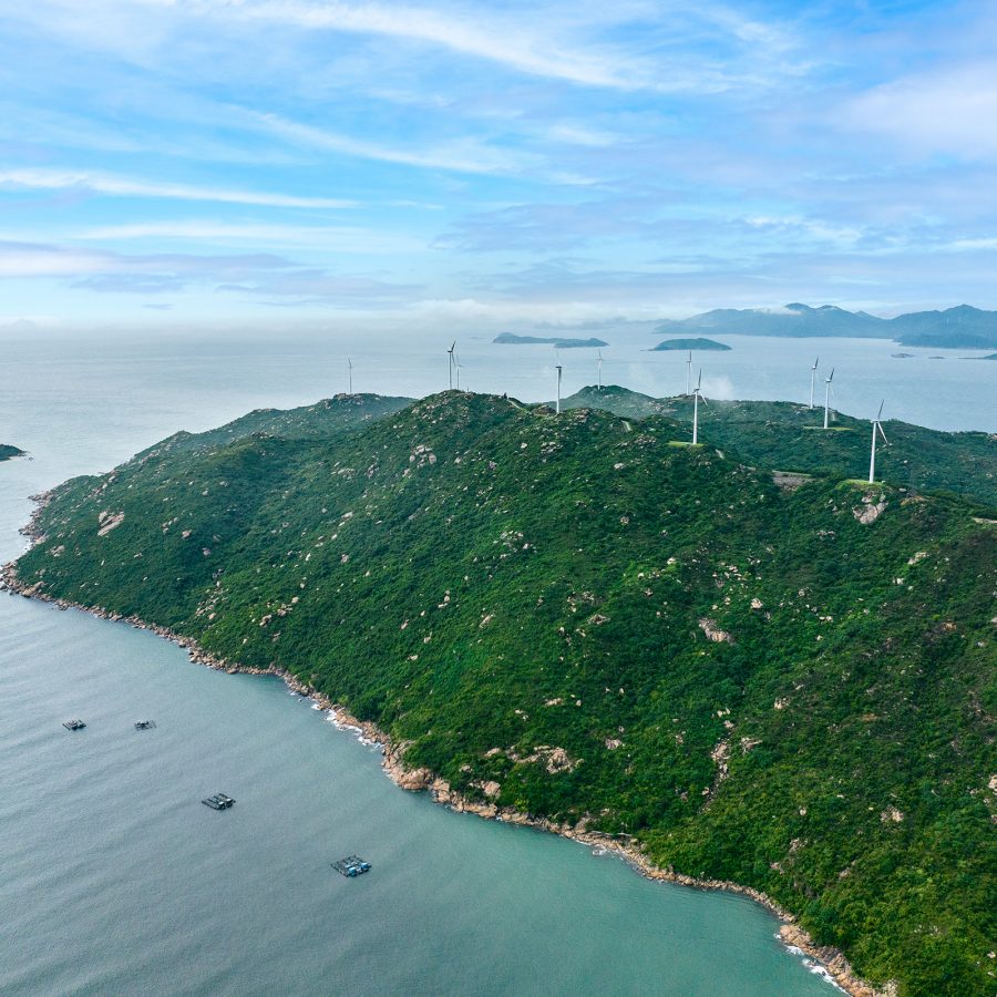 Xiachuan Island, Jiangmen from above is a small island carpeted in green and dotted with wind turbines along its topmost ridge.