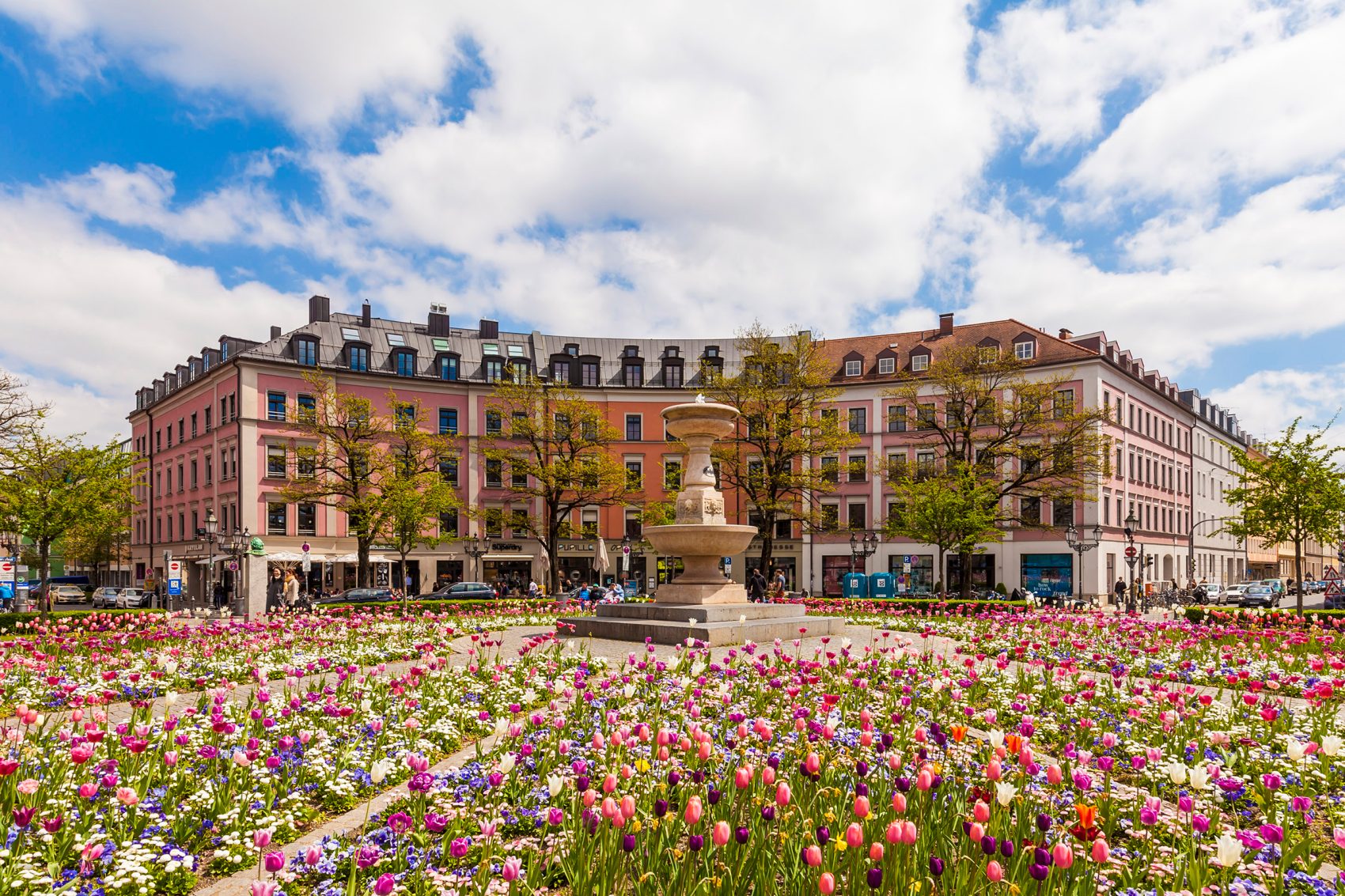 Fields of flowers and a fountain in the Gaertnerplatz roundabout in Munich.