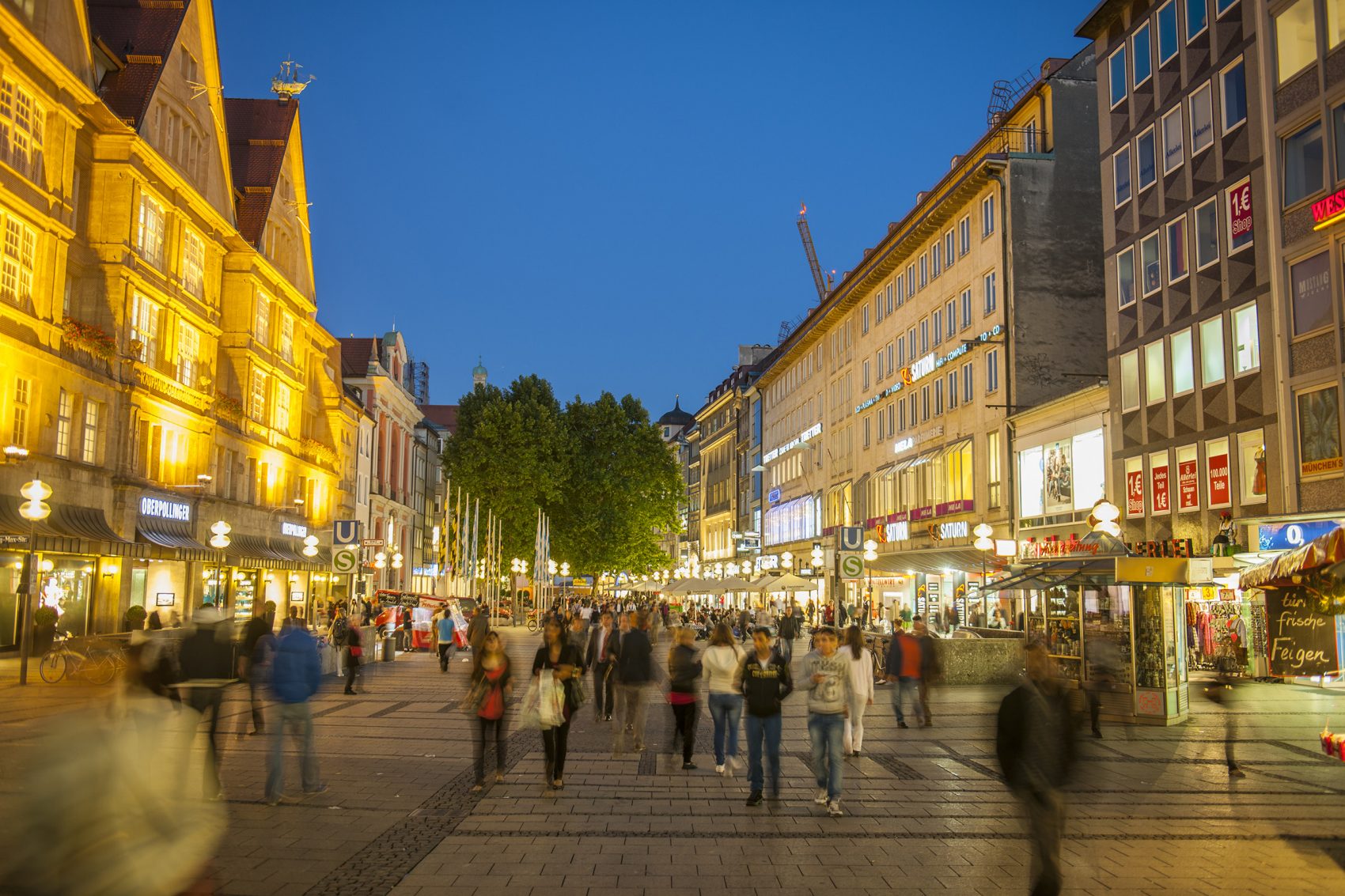 Night view of people in Neuhauser Strasse in Munich.