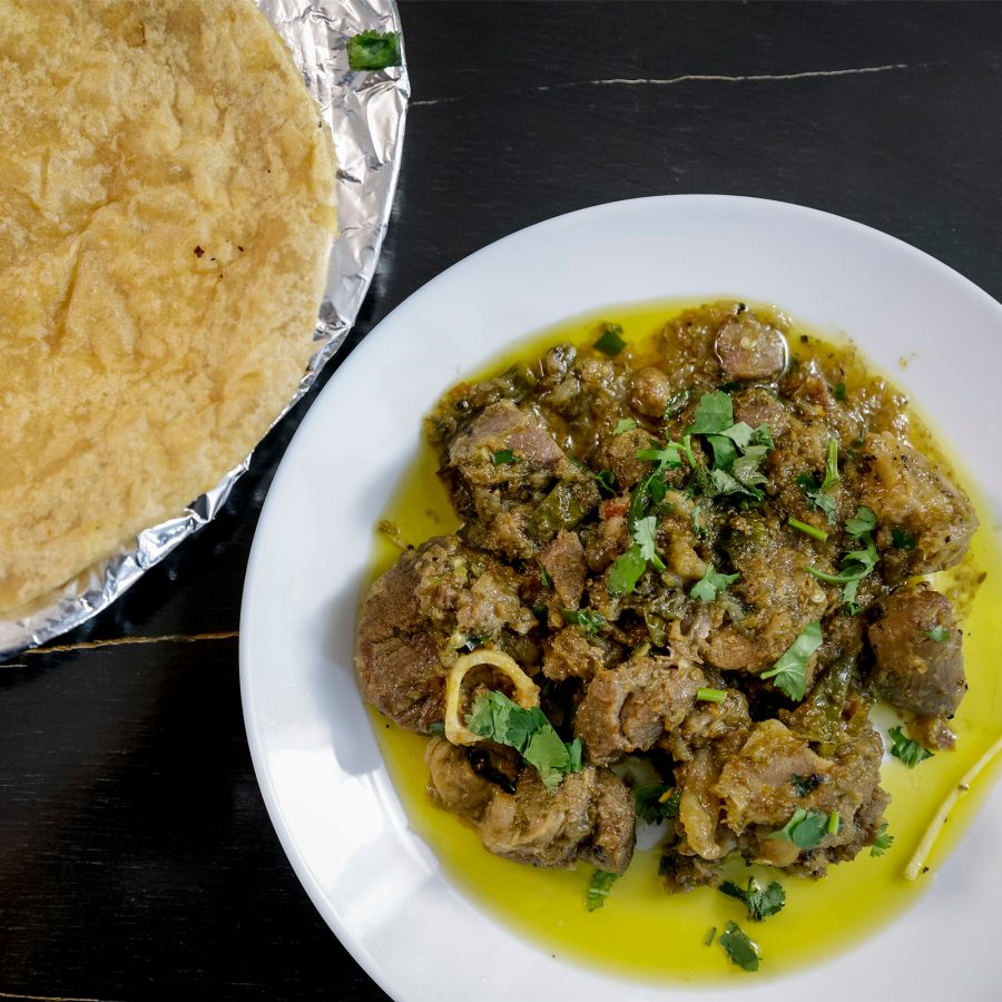 A flat lay shot of a curried dish and paratha, served at an Indian restaurant inside Chungking Mansion in Tsim Sha Tsui, Hong Kong