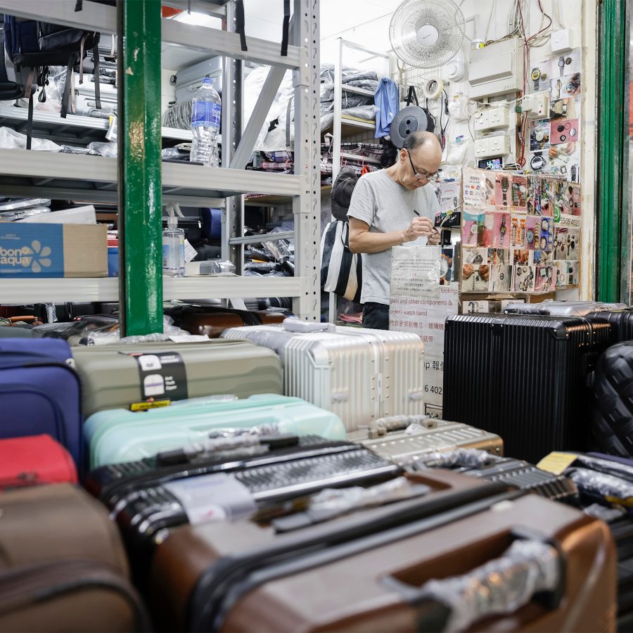 An old school shop vendor selling luggage in Chungking Mansions in Tsim Sha Tsui, Hong Kong.