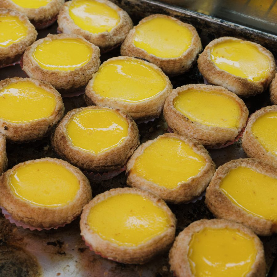 Rows of yellow egg tarts at Gold Garden Restaurant.