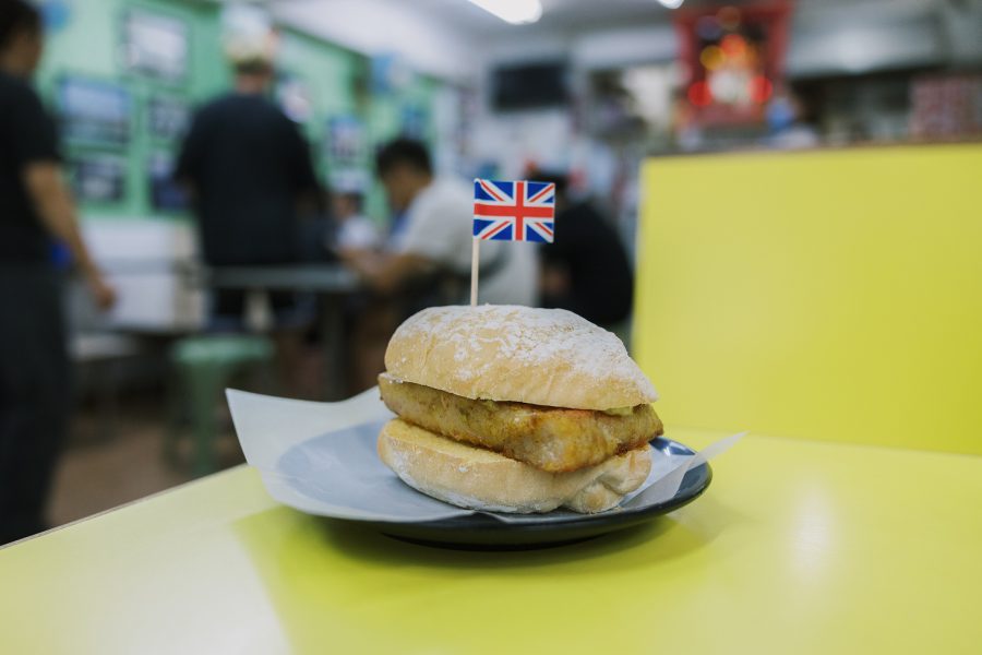 A pork chop sandwich at Mak Sun Kee with a British flag toothpick in it. 