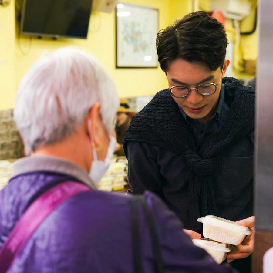 Man picks up takeaway boxes from a woman at Pei Ho Counterpart.