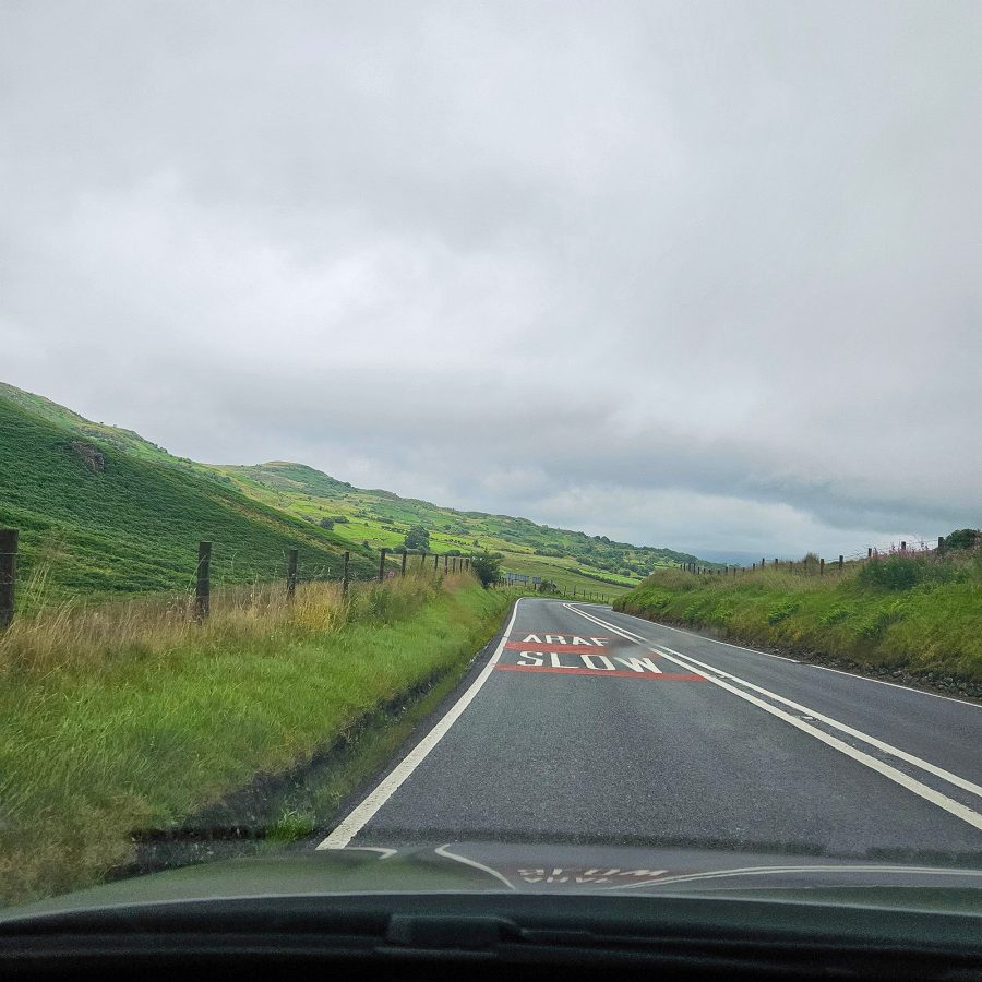Signs on the road which read ‘slow’ and ‘araf’ in Wales while driving through the countryside.