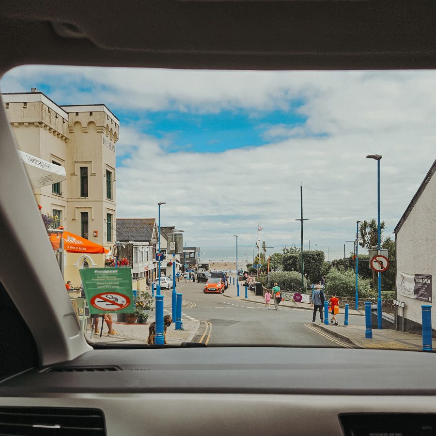 View of a Welsh seaside town through a car windshield.  
