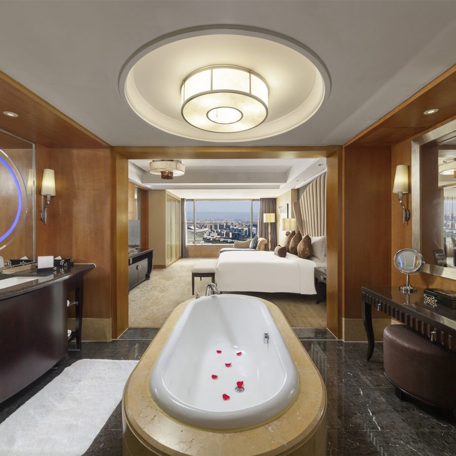 A freestanding bathtub sits in the middle of an ensuite bathroom inside a guest room at InterContinental Century City Chengdu. 