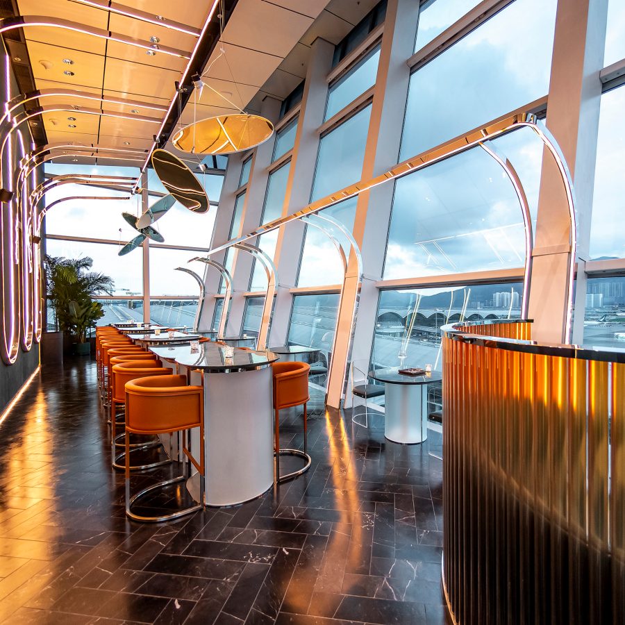 An interior view of Intervals Sky Bar and Restaurant with a view of the tarmac and runway at Hong Kong International Airport 