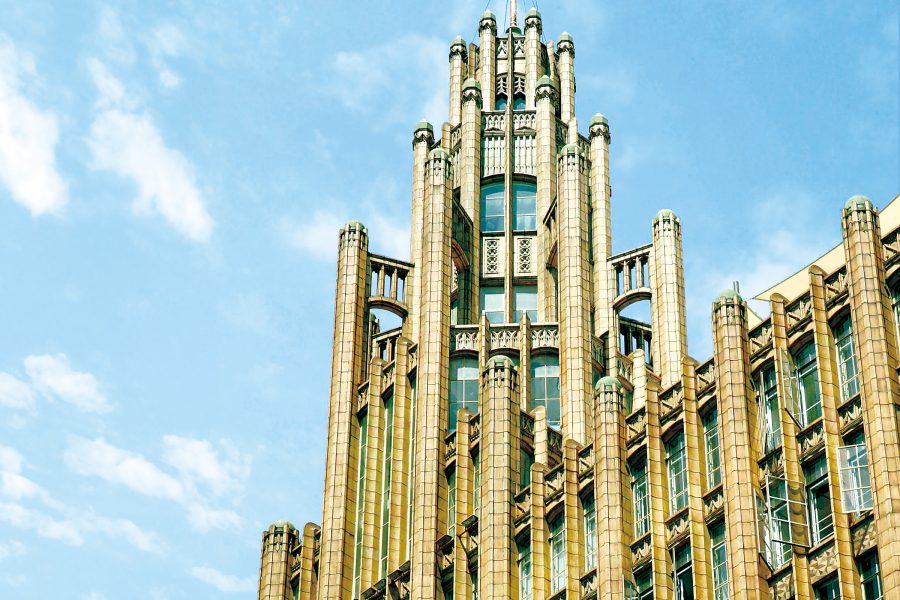 The exterior of the Manchester Unity Building, a sandy-coloured Gothic Art Deco building in Melbourne, Australia.
