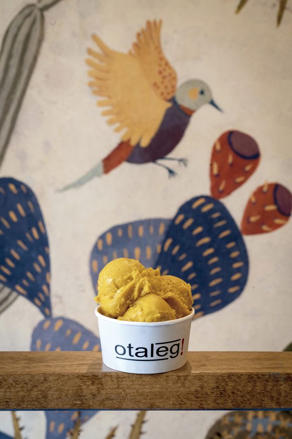 A paper cup holds three scoops of yellow gelato from Otaleg.