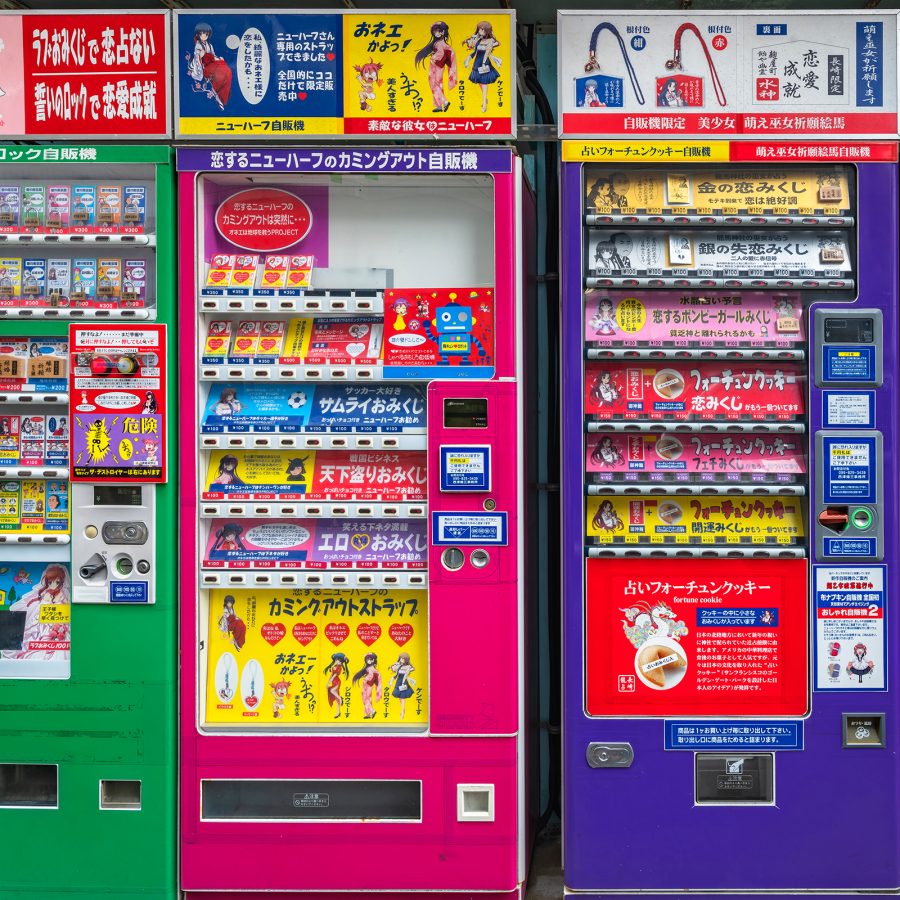 Neon green, pink and purple vending machines lined up in Japan. 
