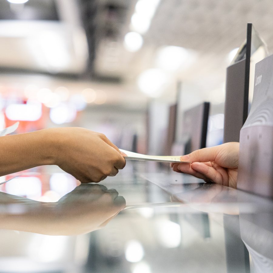  Ferry operators hand a ticket to a passenger over the counter.  