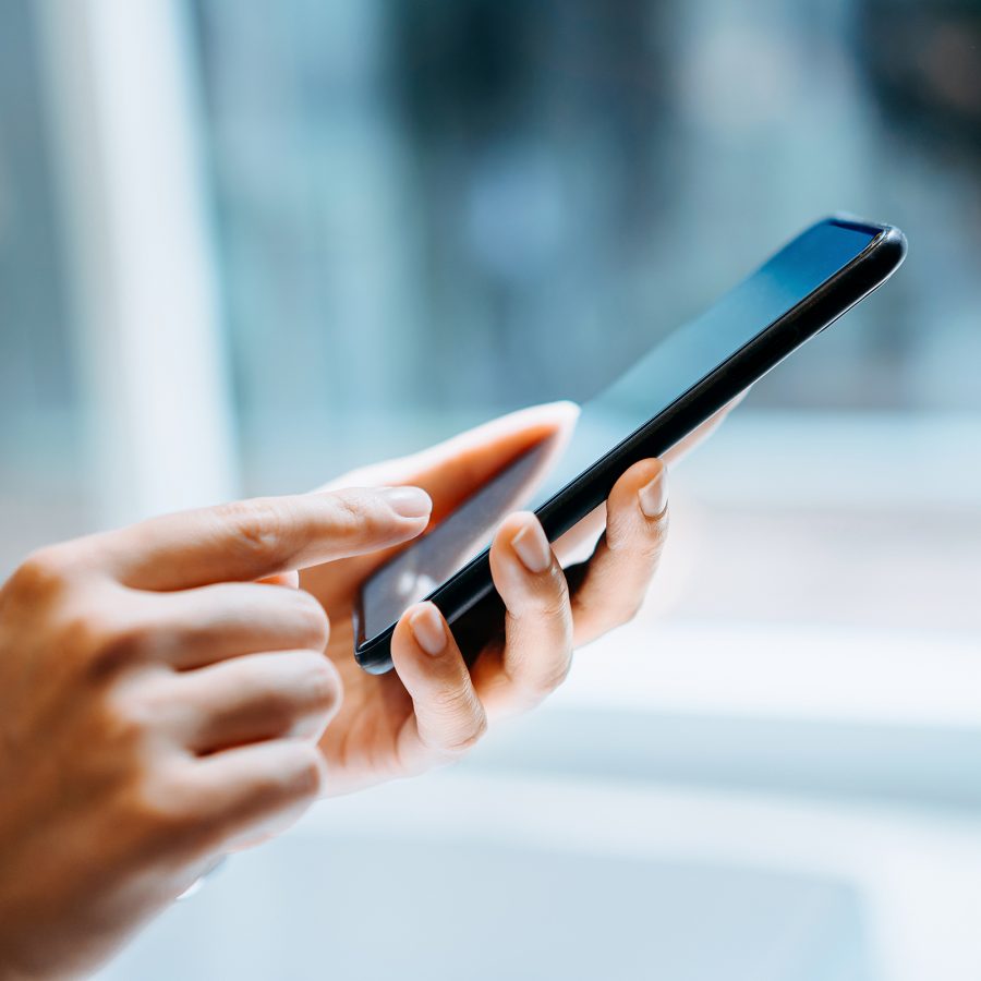 A person uses a finger to navigate a digital interface on their smartphone. 