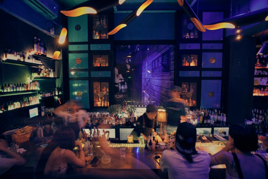 A crowd of people drinking at the bar at modern speakeasy Hope & Sesame in Guangzhou in China