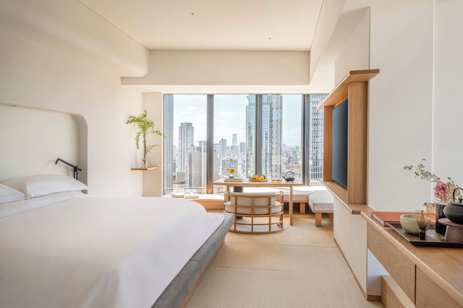 View of a white-toned room in the Four Seasons Hotel Osaka facing onto the skyline