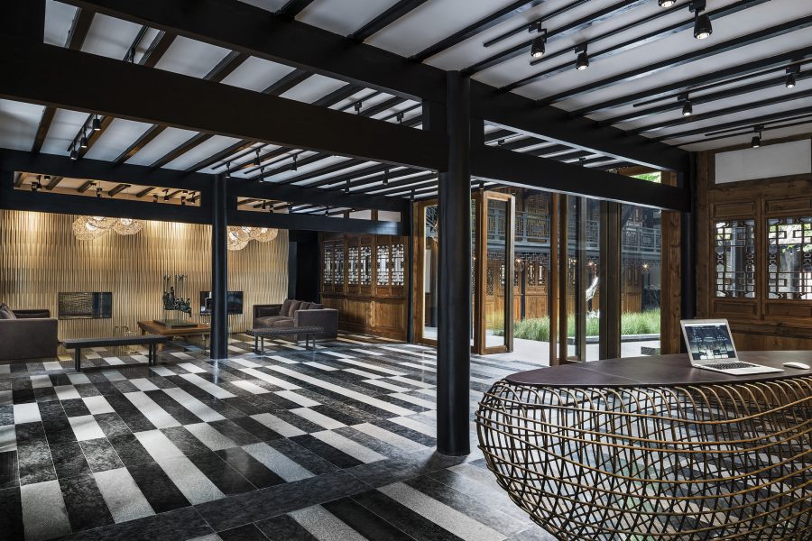 Black and white tiles dominate the reception area of The Temple House in Chengdu