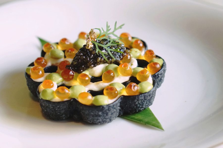 a closeup of a piece of Caviar banh nhung on a white plate served at Ănăn Saigon in Ho Chi Minh City, Vietnam
