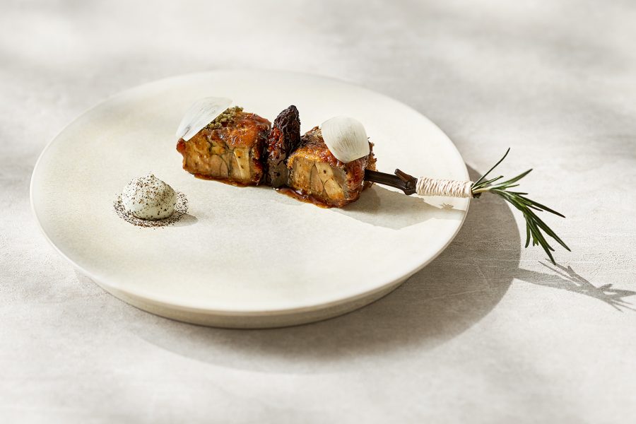 Chef Mingoo Kang’s Black Chicken served on a twig and white plate at Mingles in Seoul, South Korea
