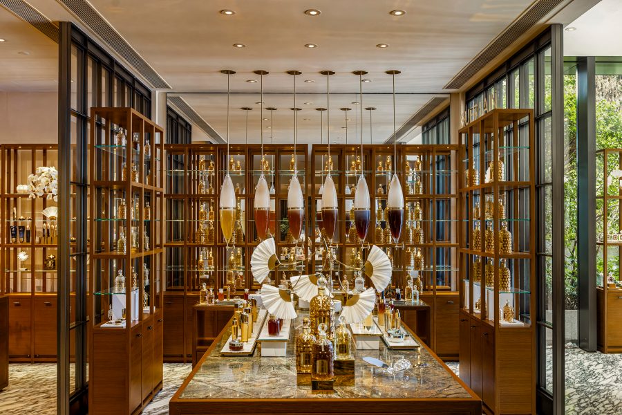 A room with shelves of gold bottles of skincare and fragrance at Asaya Spa by Guerlain in Rosewood Hong Kong.