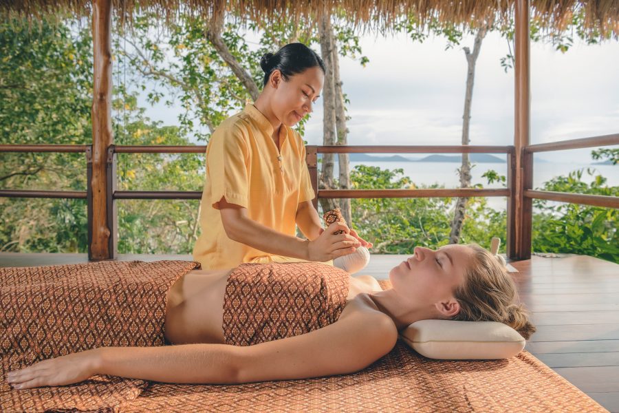 A lady receiving a massage in an open air treatment room