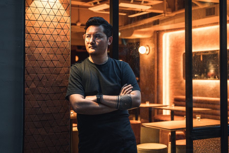 headshot of Ajit Gurung with his arms crossed, posing outside of The Savoury Project
