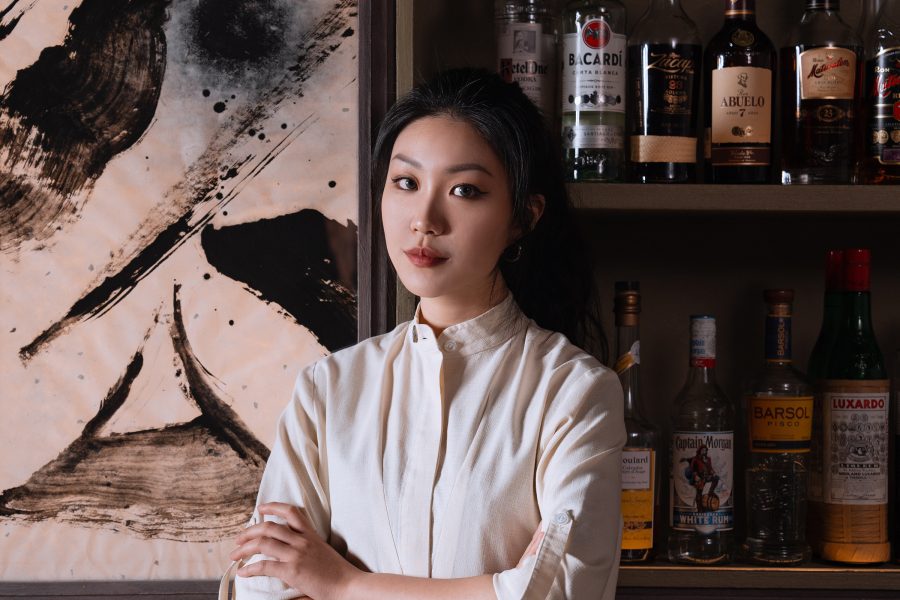 Headshot of Ariel Hou with her arms crossed
