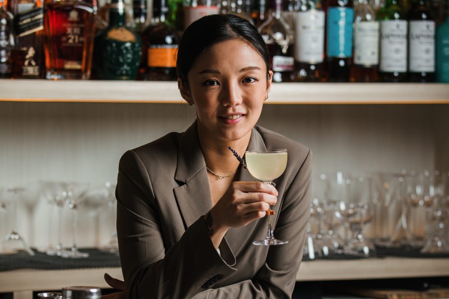 headshot of Shelley Tai holding a cocktail