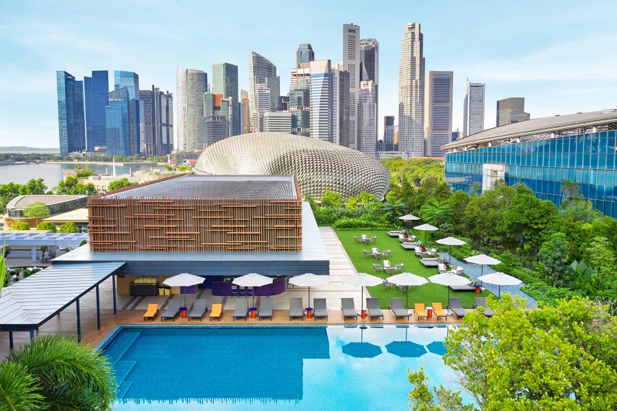 Exterior view of the swimming pool and facade of the ParkRoyal Collection Marina Bay in Singapore with the skyline in the background