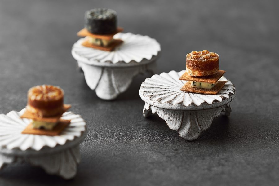 Miniature bites are served on white plates in Mingles in Seoul