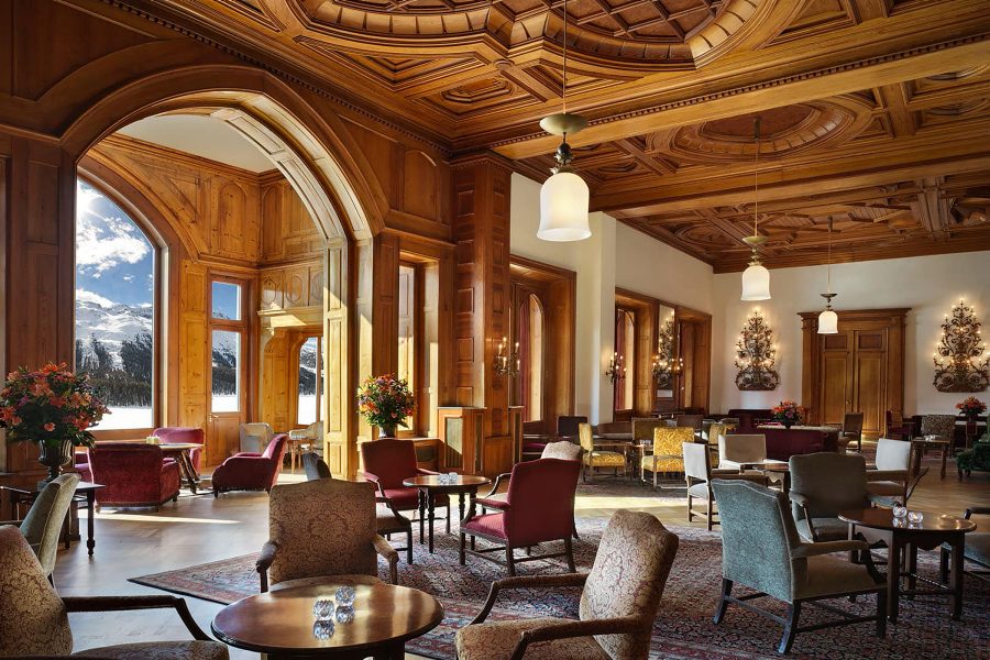 A view inside a dining room with wooden detailing at Badrutt’s Palace in St. Moritz, Switzerland