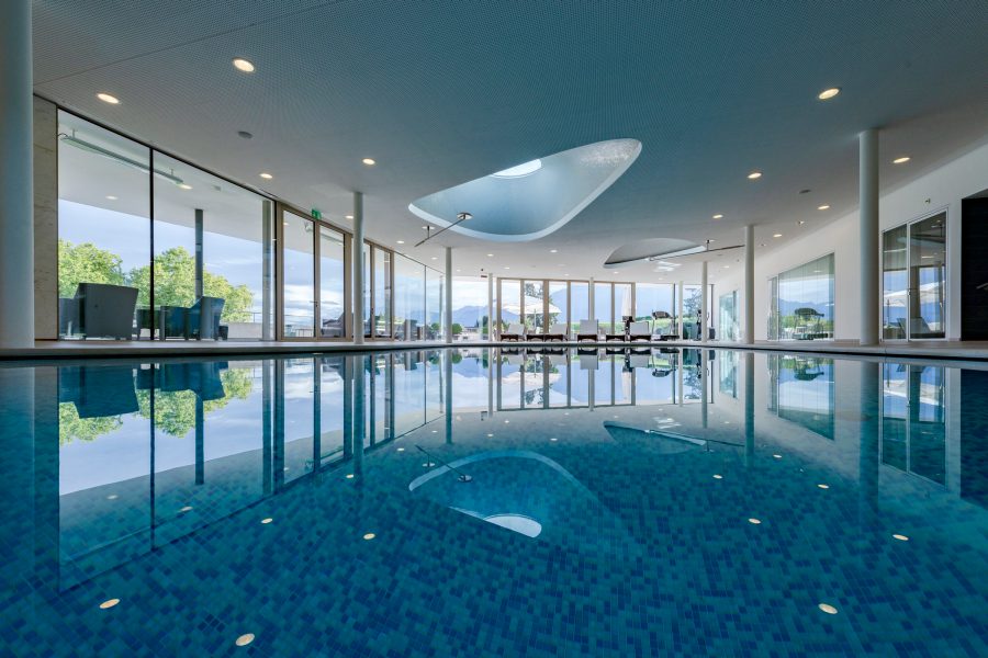 View of the blue swimming pool and triangular skylight at Clinique La Prairie in Montreaux, Switzerland