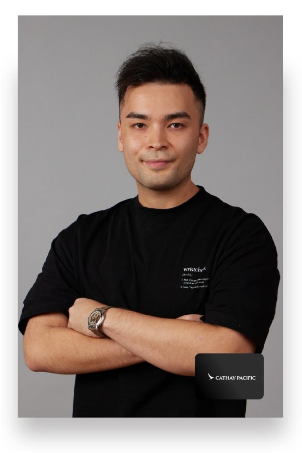  Austen Chu, founder of Wristcheck, smiles for the camera with his arms folded over his chest.